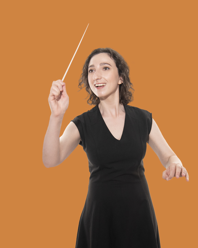 A female student, wearing a black top, waving her conductor's baton, against a warm orange background.